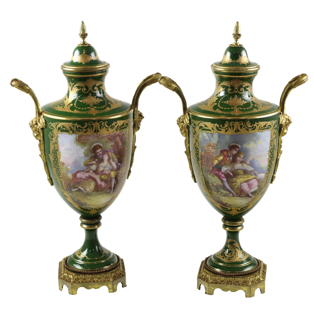 A pair of Sevres style gilt bronze mounted porcelain two-handled urns: A pair of Sevres style gilt bronze mounted porcelain two-handled urns, 20th century, each painted on either side with fete gallante or landscape within raised gilt borders, overglaze blue mark to