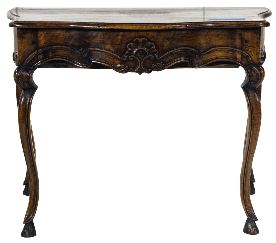 A Rococo style serpentine salon table circa 1850: A Rococo style serpentine salon table circa 1850, the apron with a shell carved medallion with sinuous carving continuing down the outswept legs, 29.5"h x 39"w x 24"d