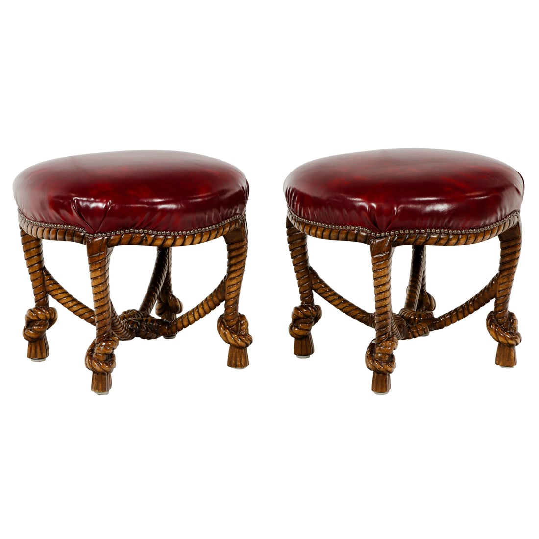 A pair of contemporary carved rope and knot form stools: A pair of contemporary carved rope and knot form stools, each having a leather seat with brass nail head trim, rising on the naturalistic base, 21"h x 22"dia