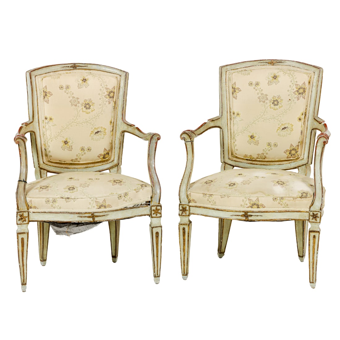 A pair of French polychrome fauteuils: A pair of French polychrome fauteuils, each armchair with floral upholstery and a paint decorated body with gilt and crimson accents, rising on square tapered legs, 36.25"h x 23.75"w x 19.25"d (seat)