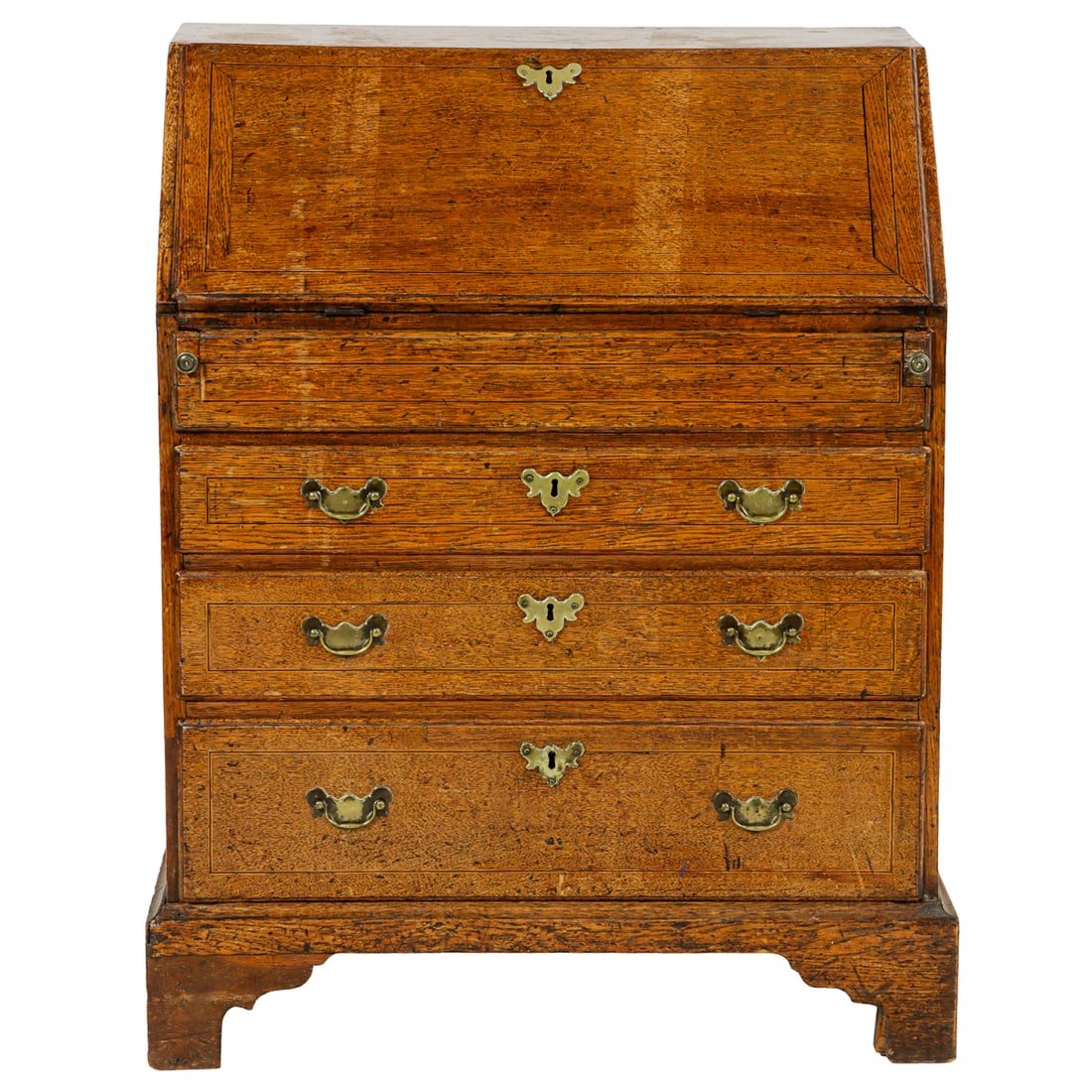 A Georgian slant front desk: A Georgian slant front desk, with a fall front opening to stationary slots and hidden compartment, with graduated drawers and rising on bracket feet, 39"h 30.25"w x 18"d