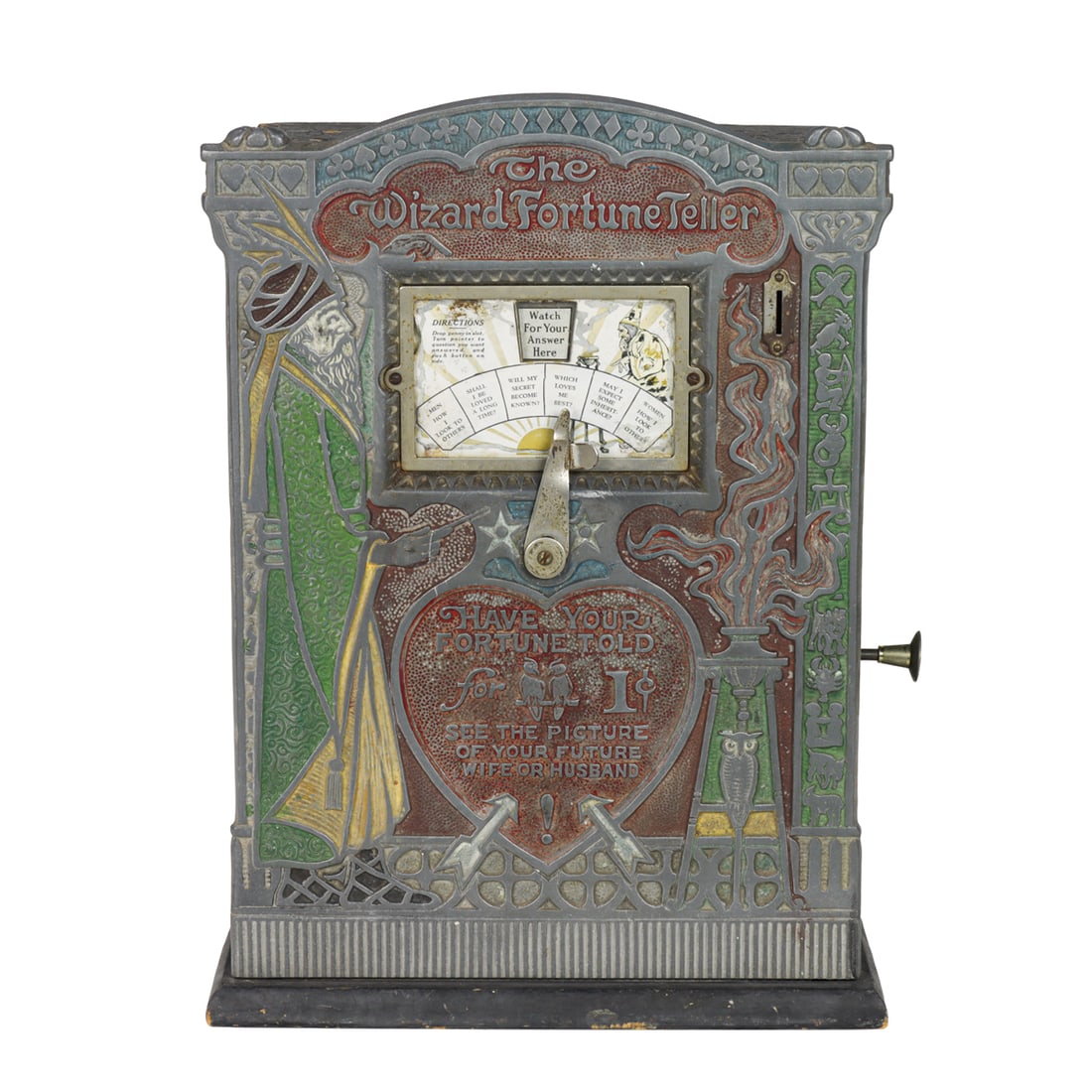 A Mills 'The Wizard Fortune Teller' coin operated arcade machine: A Mills 'The Wizard Fortune Teller' coin operated arcade machine, circa 1926, featuring wood case and paint decorated cast aluminum front, 18.5"h x 13.5"w x 6"d