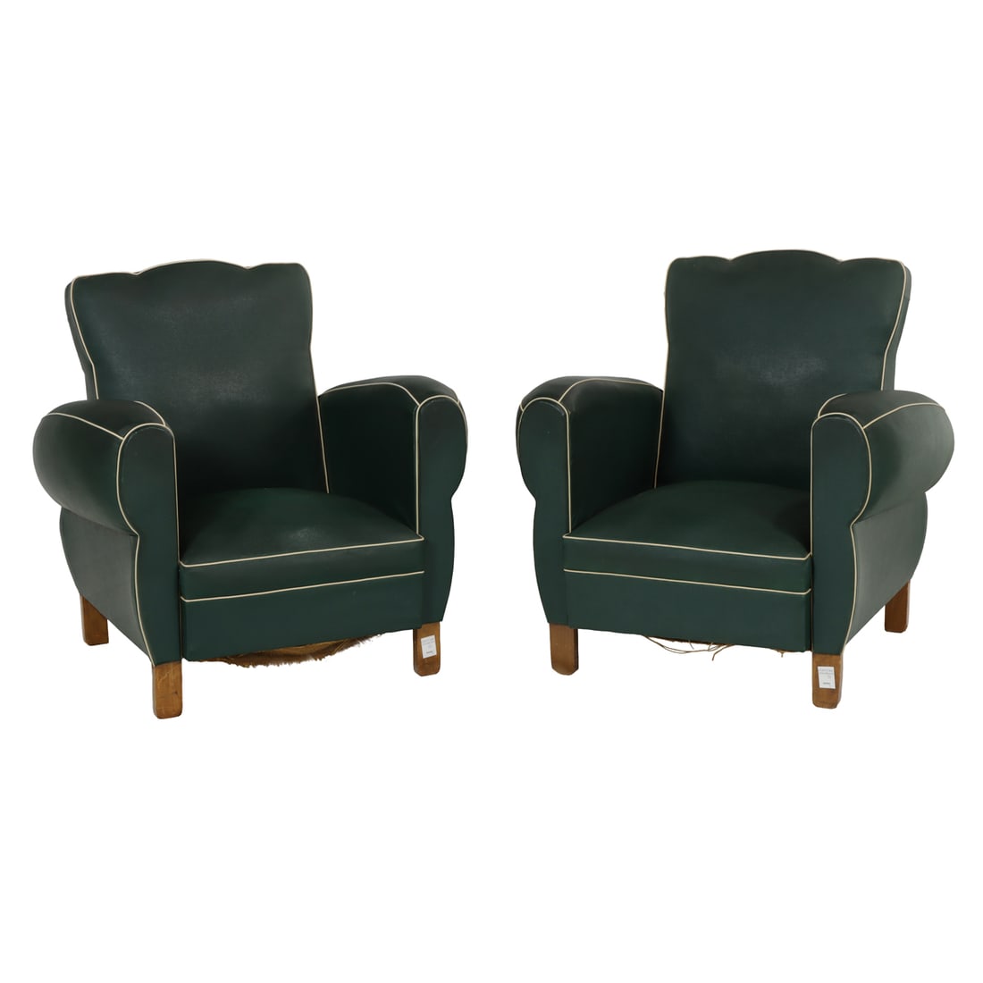 A pair of Art Deco club chairs: A pair of Art Deco club chairs, each upholstered in green faux leather with white piping, 32.5"h x 28.5"w x 20.5"d (seat)