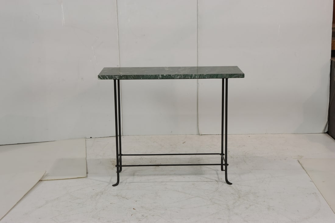 A console table with green marble top raised on iron supports: A console table with green marble top raised on iron supports, en suite with previous lot, marked with retailer tag for 'Zambezi Trading Co.', 32"h x 39.5"w x 15.75"d