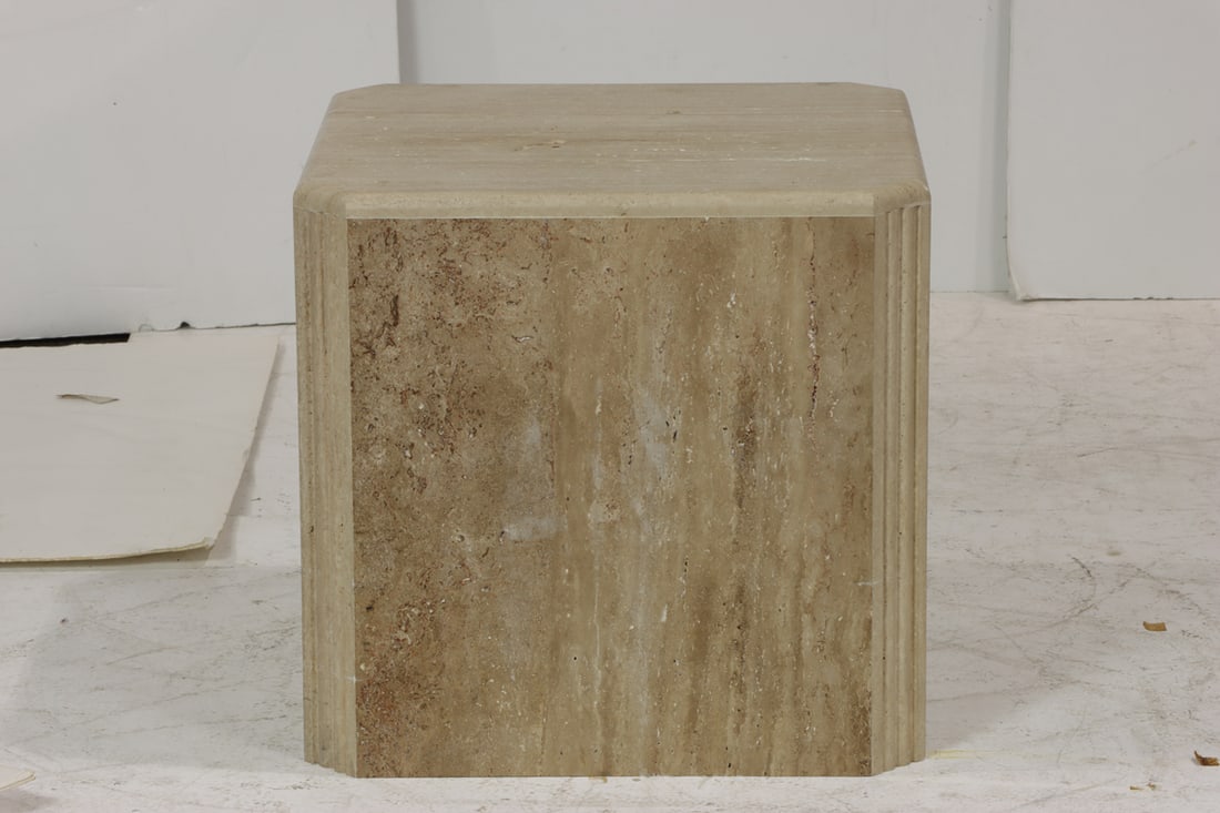 A travertine pedestal table: A travertine pedestal table, of square outline with fluted corners, 22.25"h x 25.25"w