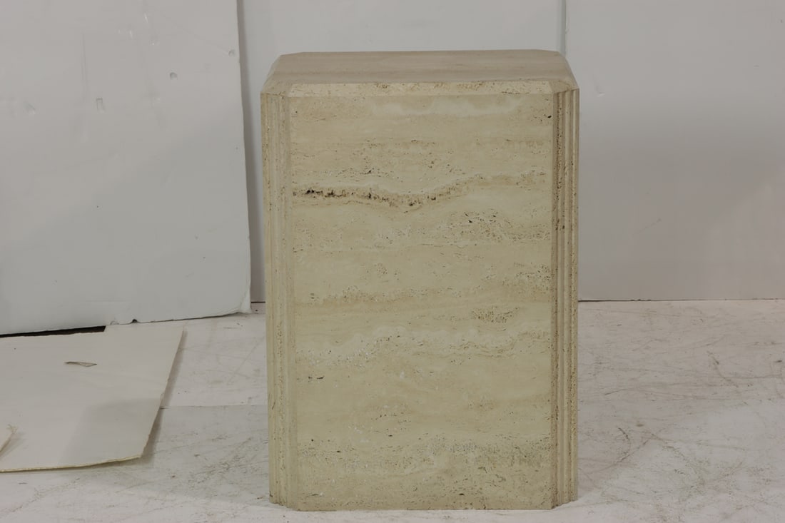 A travertine pedestal table