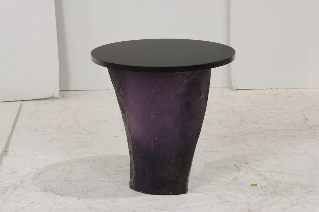 A Modernist amethyst resin and ebonized sculptural side table: A Modernist amethyst resin and ebonized sculptural side table, the organic form base supporting a round top, unmarked, 19.5"h x 20.5"dia