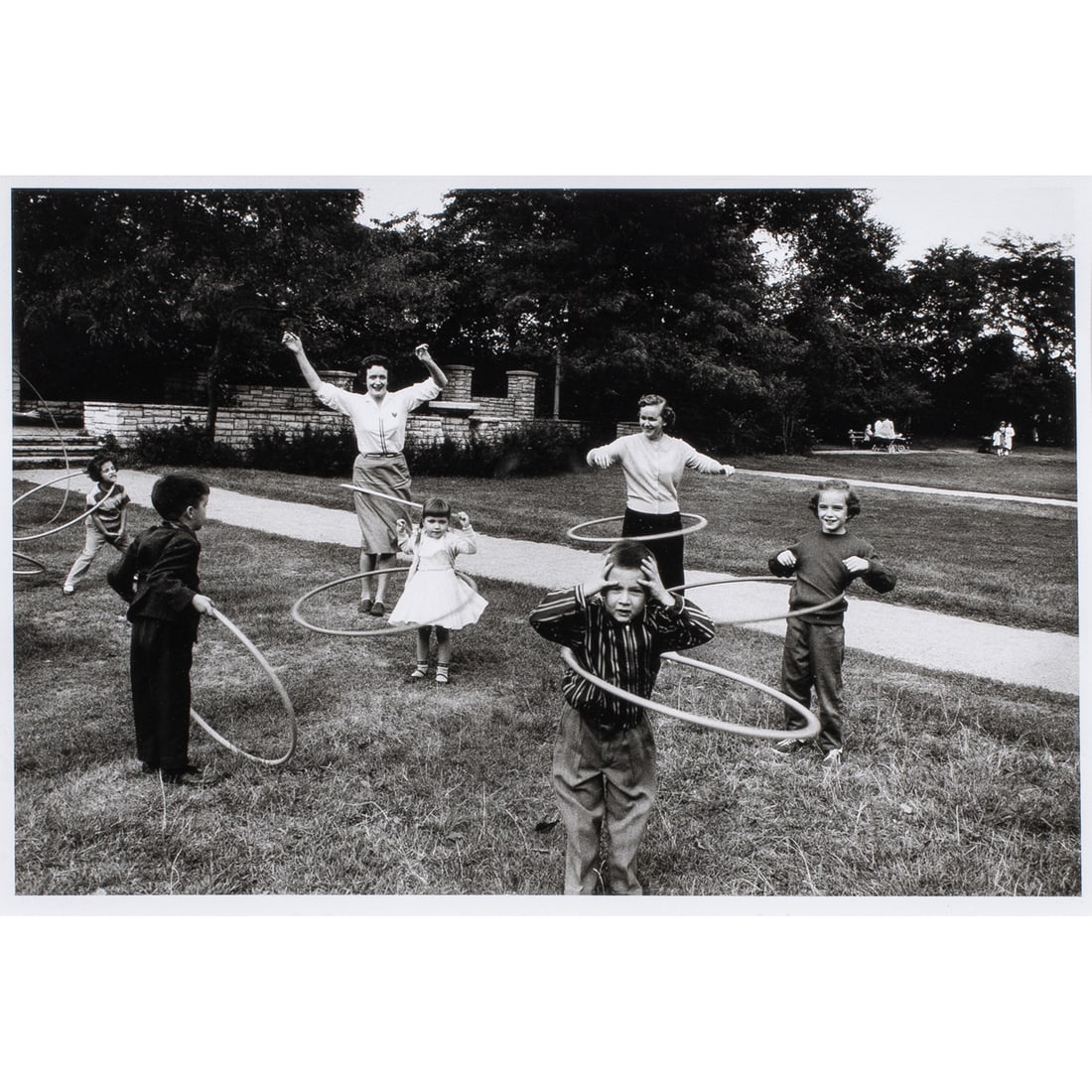 Photograph, Mickey Pallas: Mickey Pallas (American, 1916-1997), "Hula Hoopers," gelatin silver print, gallery label (Fraenkel Gallery, San Francisco, CA) affixed verso, sight: 6.75"h x 10.75"w, overall (with frame): 16.75"h x