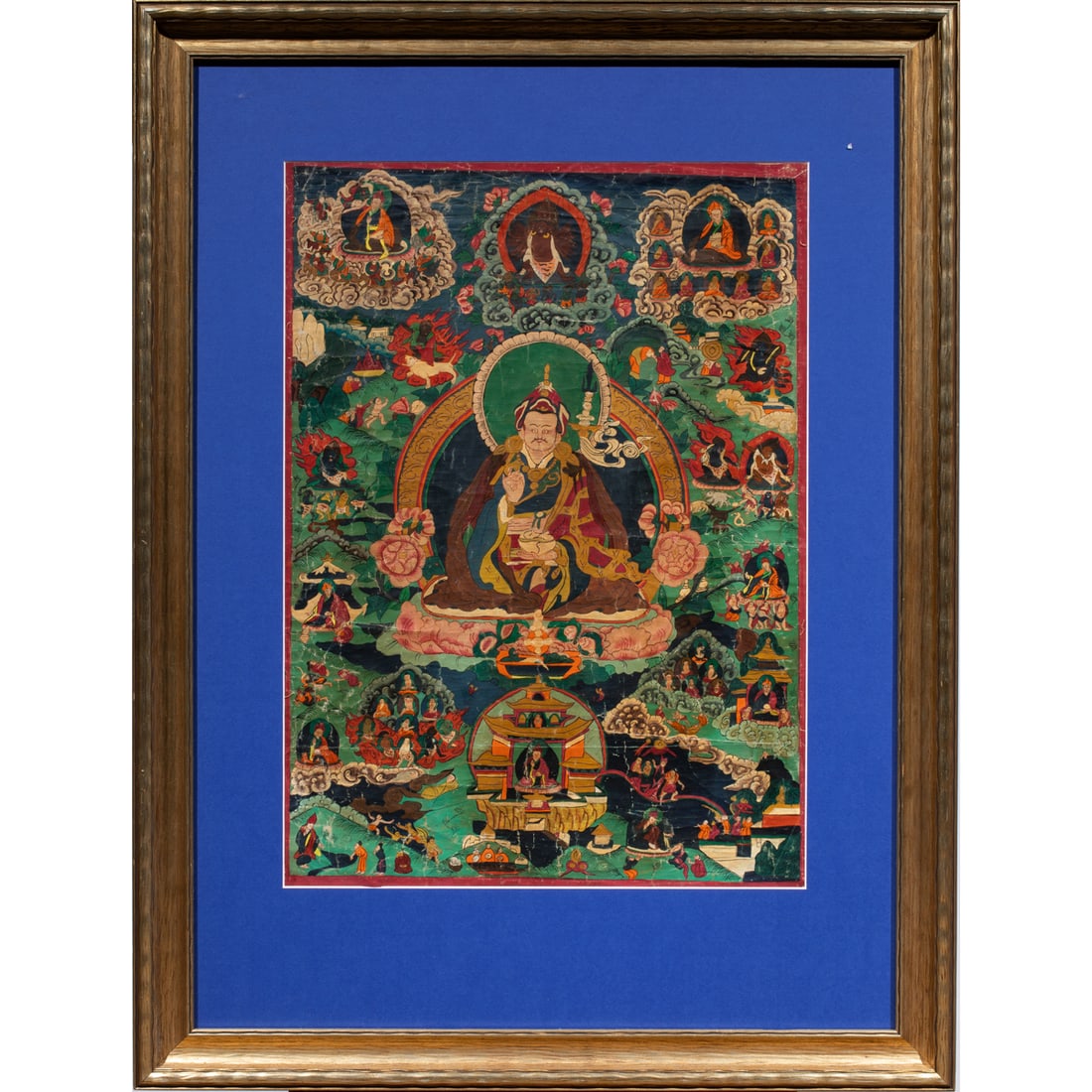 A Tibetan thangka of Padmasambhava: A Tibetan thangka of Padmasambhava. Distemper on canvas, framed and glazed, 26,75"h x 18.75"w.