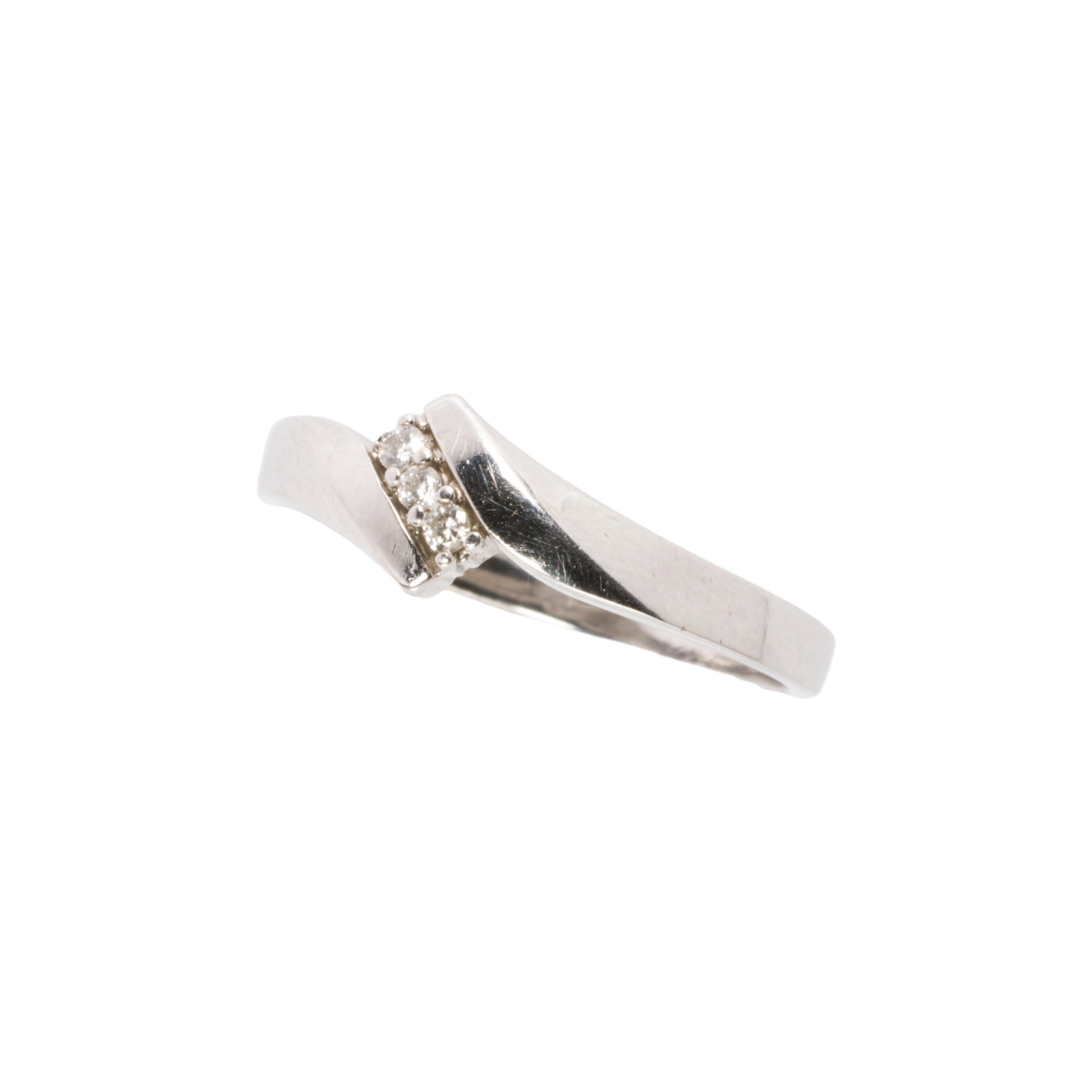 A diamond and 10k white gold band: A diamond and 10k white gold bandfeaturing three round brilliant-cut diamonds; size: 6 1/2; 1.6 grams
