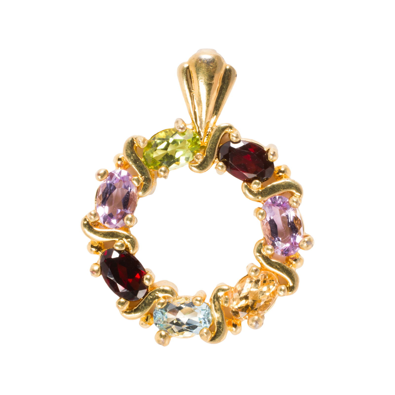 A gold tone, gem-set pendant: A gold tone, gem-set pendantDesigned as a ring of seven oval-cut gemstones including garnet, amethyst, and citrine; length: 1 1/8 in; 5.25 grams