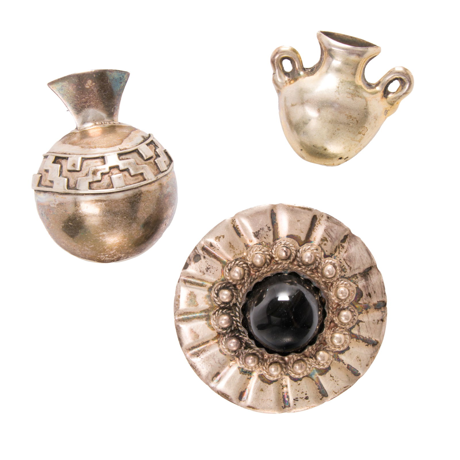 Three mexican silver art brooches: Three mexican silver art broochesTwo designed as vessels, together with one set with a round-shaped hardstone cabochon measuring 18.85 mm; lengths: 2, 1 1/4, and 2 1/4 in, respectively; gross weight: