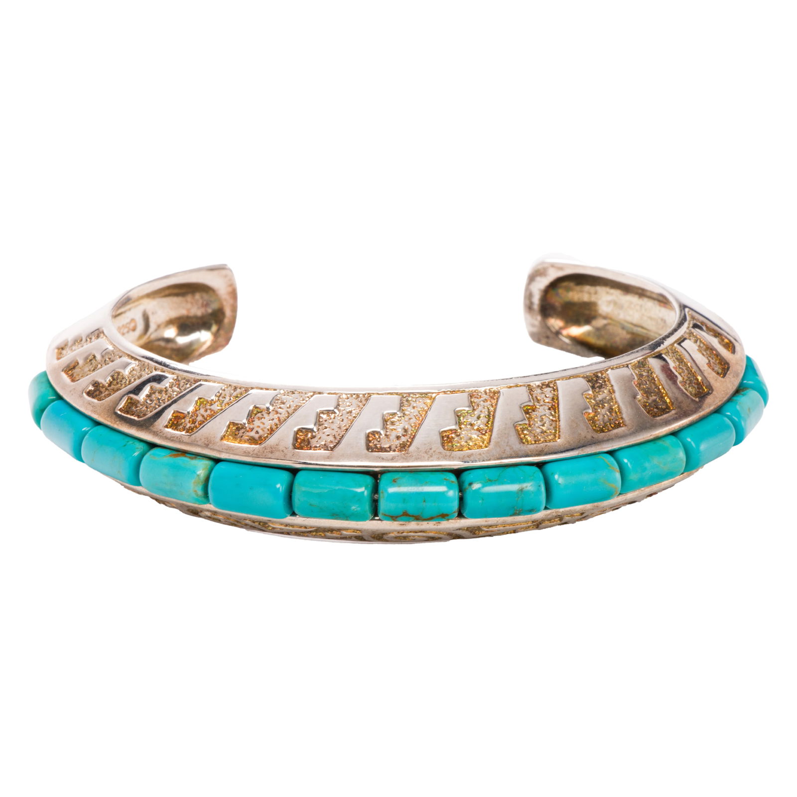 A Native American style turquoise and sterling silver cuff: A Native American style turquoise and sterling silver cuffDesigned with a channel of 13 cylindrical turquoise beads measuring 8.36 mm, accented by repeating geometric patterning; interior length: 5