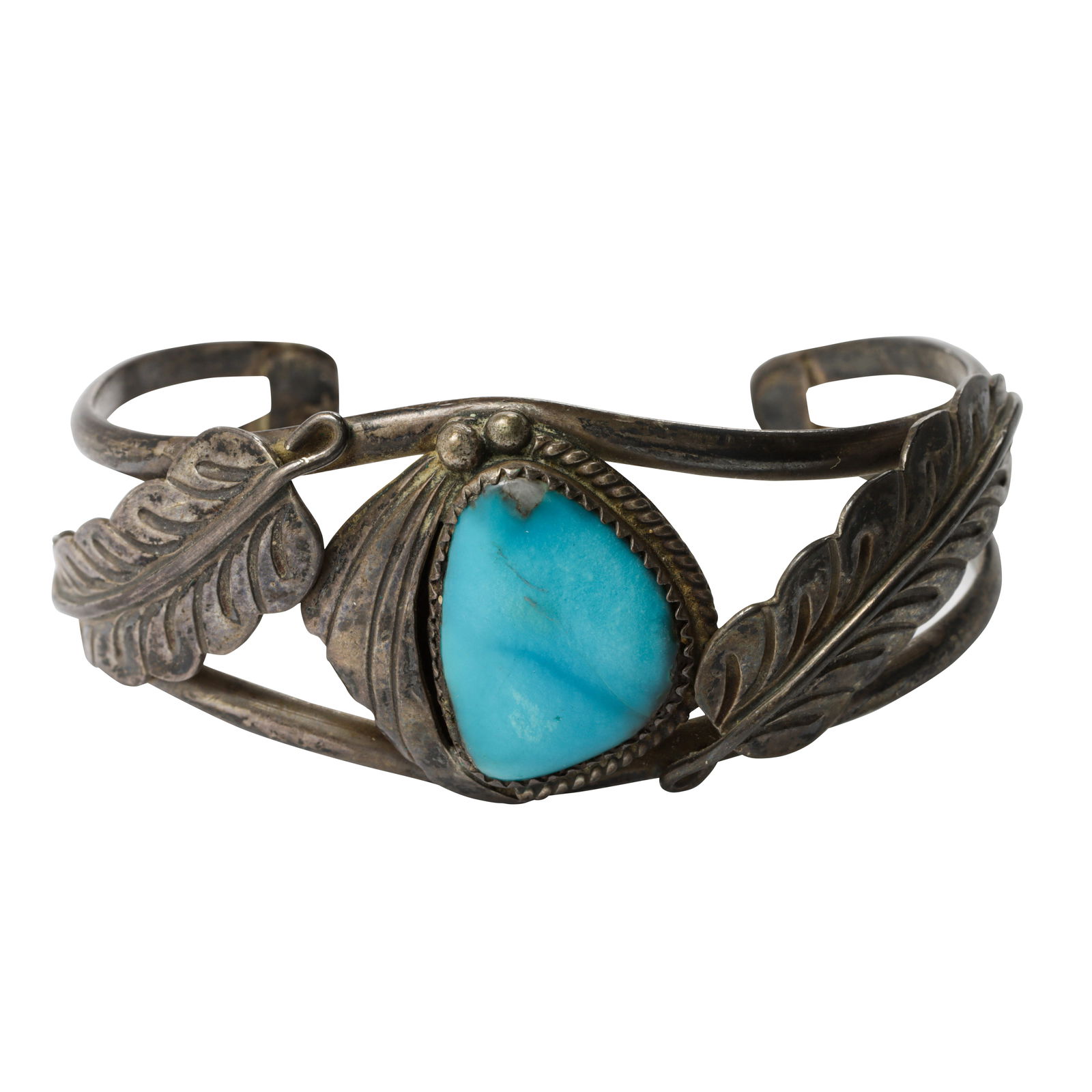 A Native American turquoise and silver bangle: A Native American turquoise and silver bangleof botanical design, centering a turquoise cabochon measuring approximately: 19.40 x 12.94 mm; marked with arrow makers mark; interior circumference: 6
