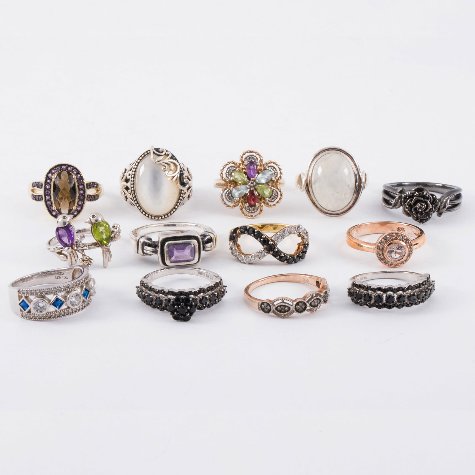 A group of silver and hardstone rings: A group of silver and hardstone ringsComprising a variety of silver and hardstone rings including moonstone; gross weight: 53.25 grams