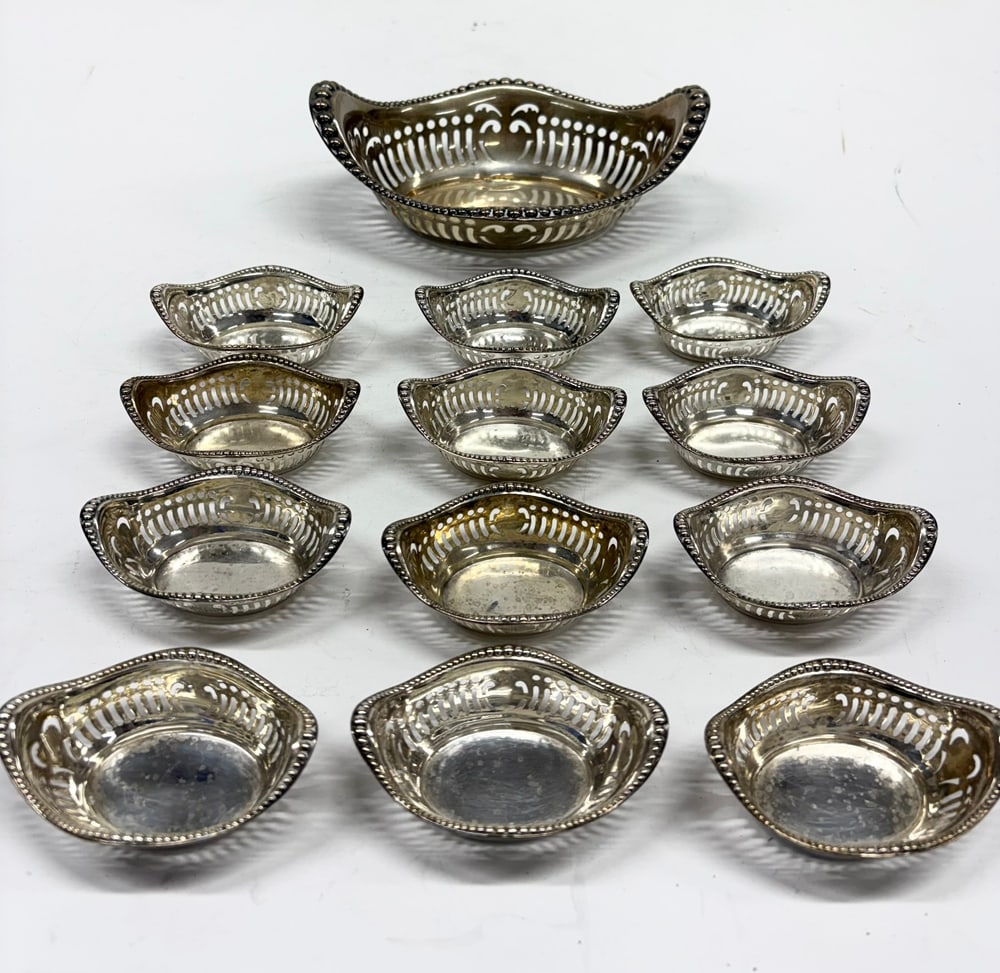 An American Gorham Sterling Nut Dish Set: A Gorham nut dish set, all monogrammed 'MFC', comprising (1) reticulated bowl, 7.25"l and (12) small reticulated dishes, 3.25"l, 11.29 troy oz [13 total]
