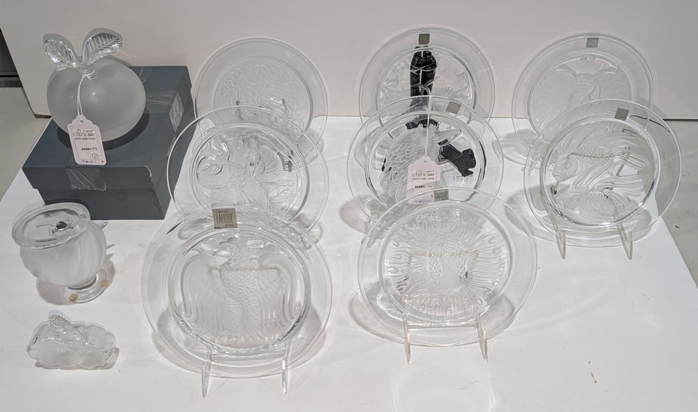 A group of Lalique glass: A group of Lalique glass, comprising (1) Grande Pomme apple perfume bottle with factory presentation box, 5.5?h; (1) Deux Fleurs perfume bottle, 3.75?h; (1) Rosine vase, 5?h and (8) collector plates