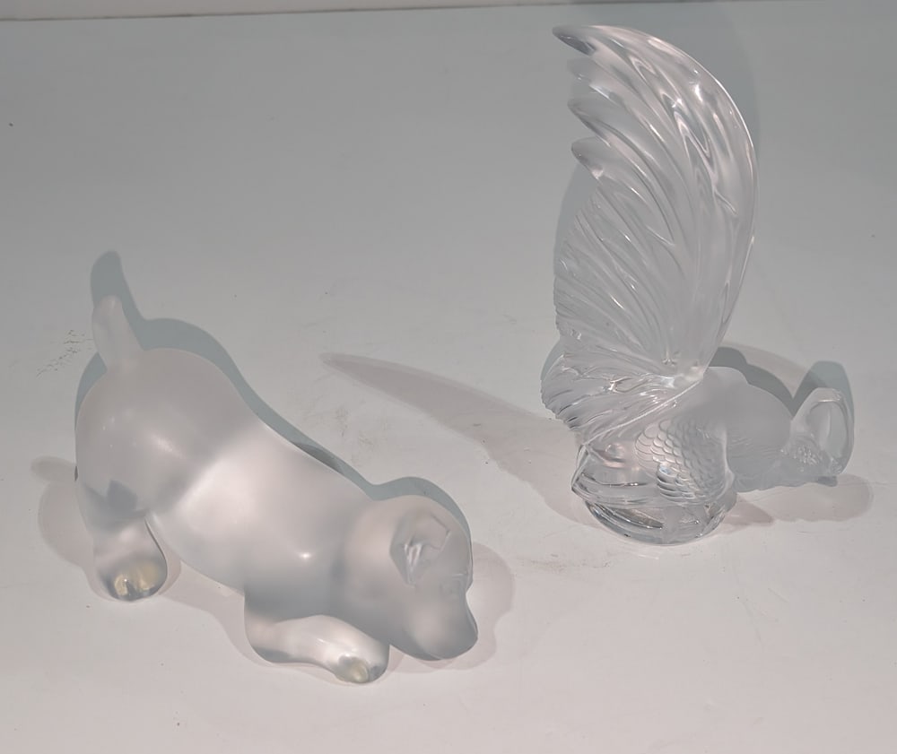 A Lalique Glass Rooster and Puppy Dog: Two Lalique glass animals, each with engraved factory signature, the first Coq Nain rooster, 8?h; the second figure of a mischievous puppy dog, includes factory presentation box, 7?l [2 total + 1 box]