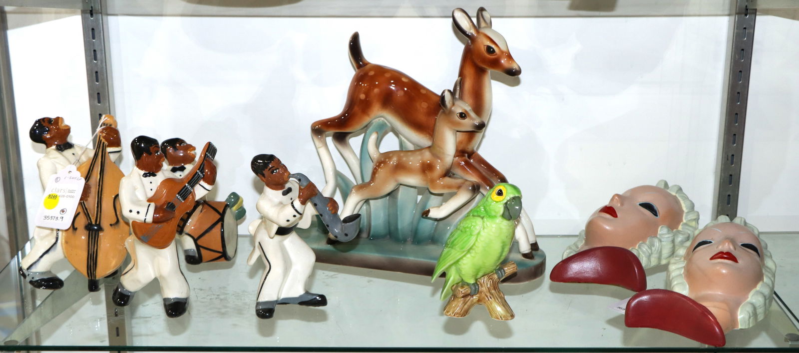 A Group of Art Deco Ceramic Decorations: A group of Art Deco ceramic decorations, comprising (1) West Coast pottery four piece jazz band, unmarked, greatest 7?h; (1) Goldschneider group of fawn and doe, 533, 11.5?h; (1) figure of a parrot, 5