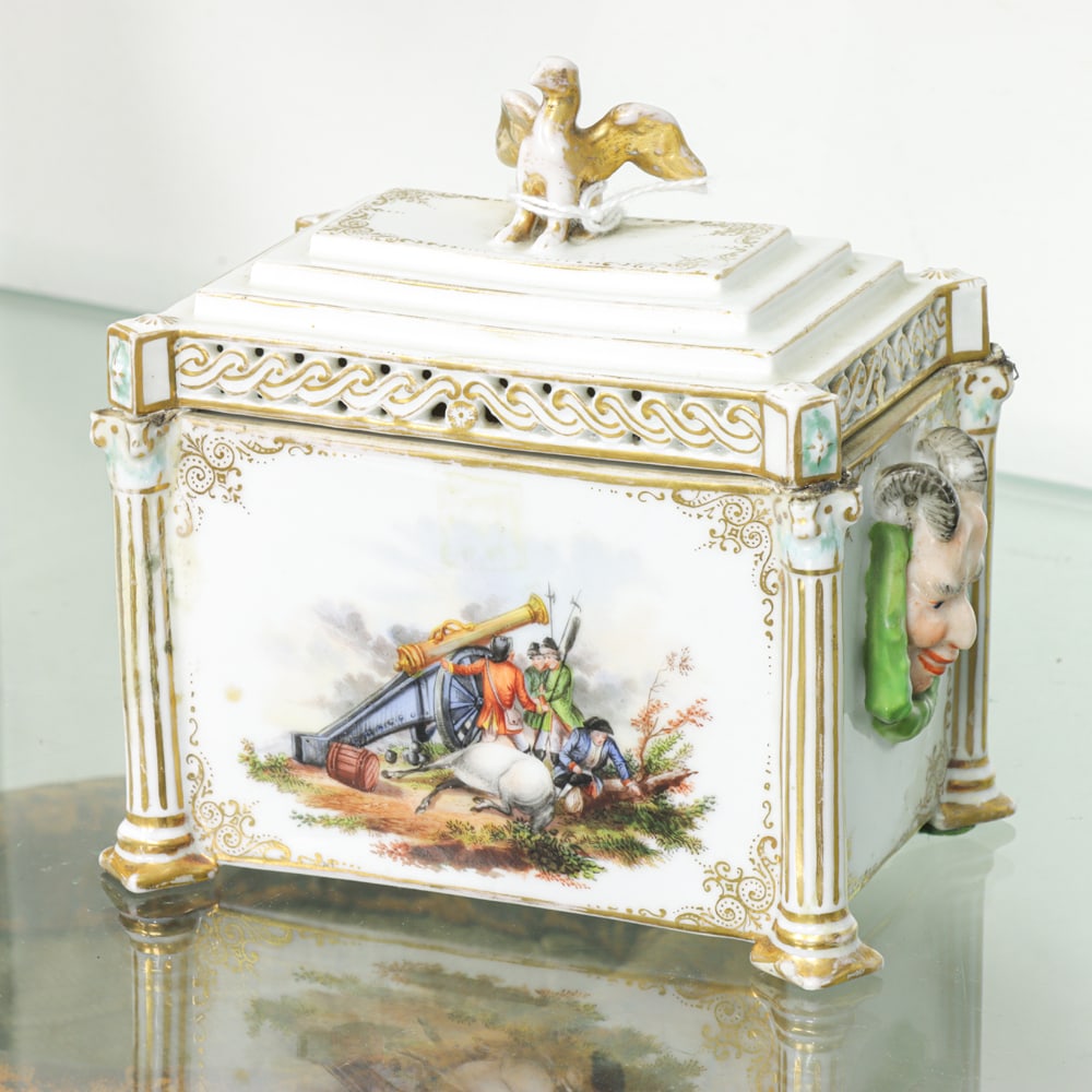 A Continental porcelain table casket: A Continental porcelain table casket, 19th century, painted with military scences and flanked by satyr handles, 4.75"h x 4.5"w