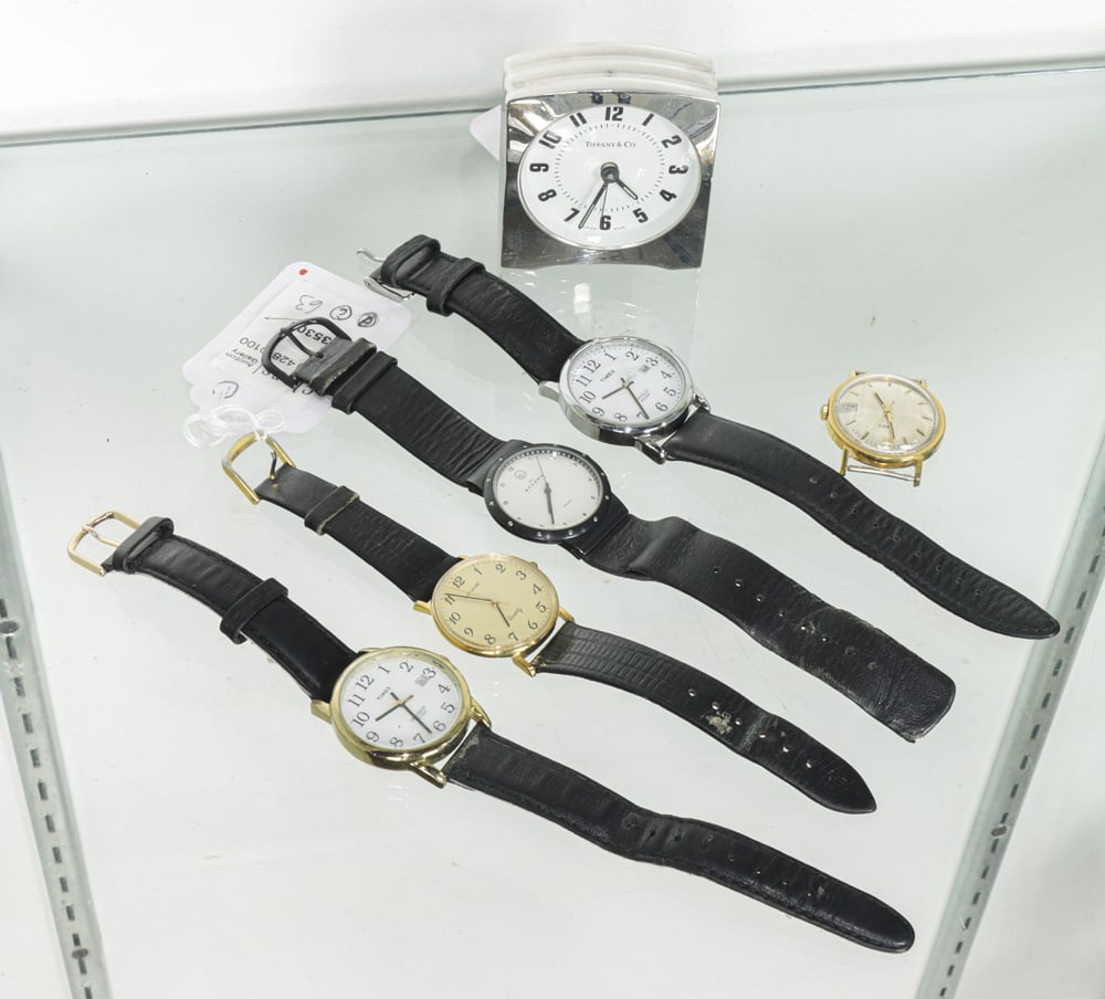 Five wrist watches and a Tiffany Desk Clock: An assembled group, including (5) men's wrist watches and a (1) Tiffany & Co. chromed metal alarm desk clock, 2.5"h [6 total]