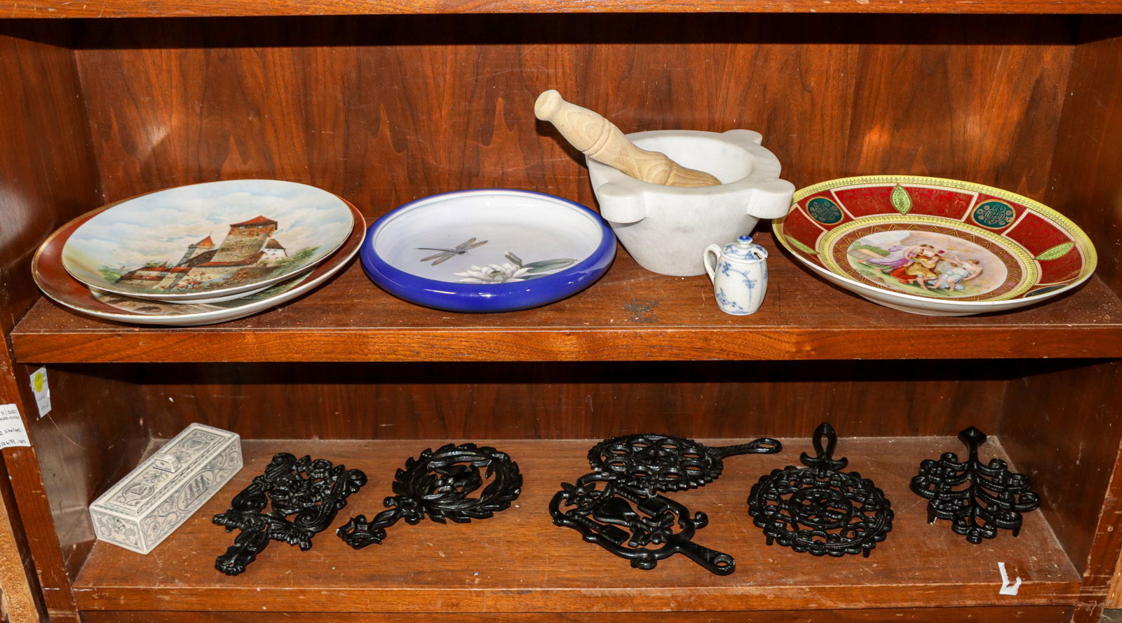 An assembled group of porcelain and other articles: An assembled group of porcelain and other articles including (1) marble mortar; (1) Royal Copengagen porcelain low bowl; (1) faux scrimshaw box with dominoes, (6) cast iron trivets and others [14