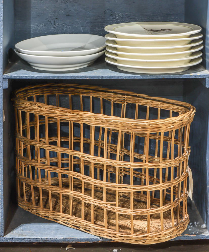 An assembled group of ceramic platters with a French woven bread basket: An assembled group of ceramic platters and French woven bread basket, comprising (1) basket, 19.5"h x 33"w x 15.5"d; (6) large Carlo Marchiori handpainted seafood plates, 15.5"dia; and (1) pair of