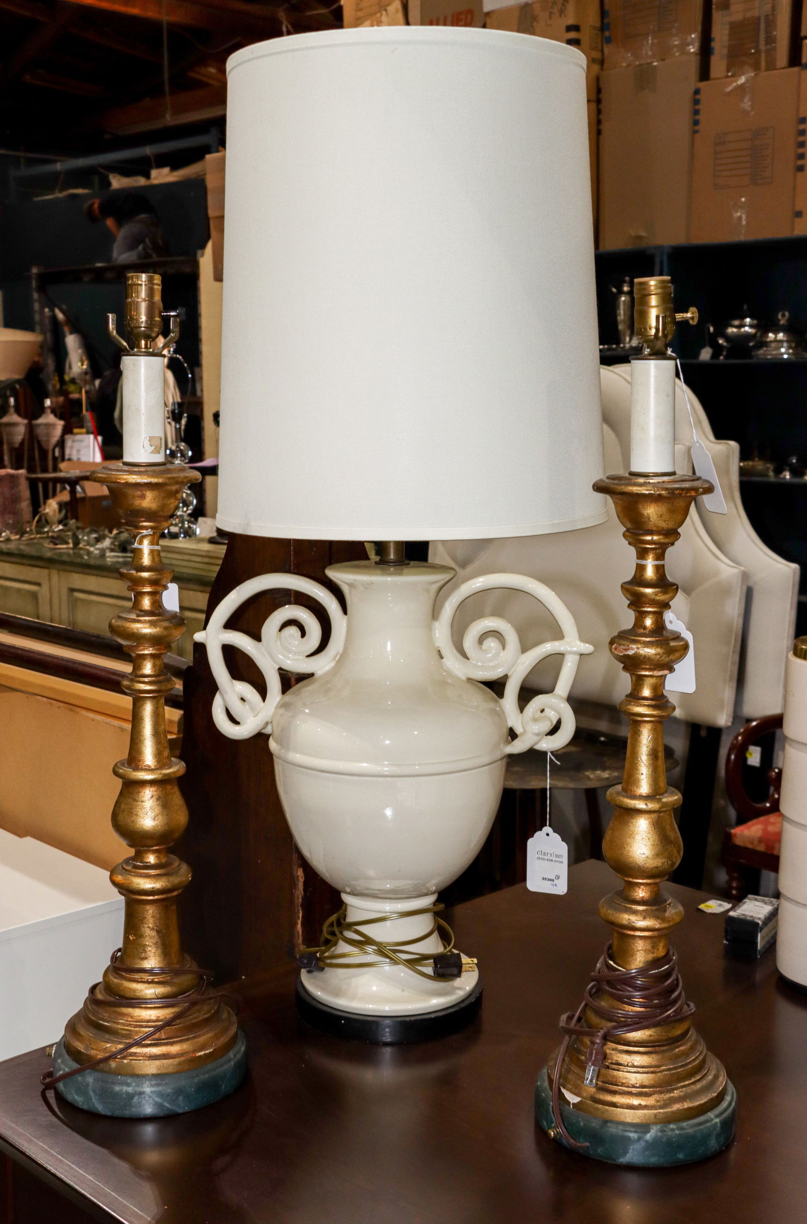 A group of three table lamps: A group of three table lamps, comprising pair of Continental giltwood candle prickets, 31"h and Italian pottery urn form lamp, 19"h (base) x 17"w x 14"dia [3 total]