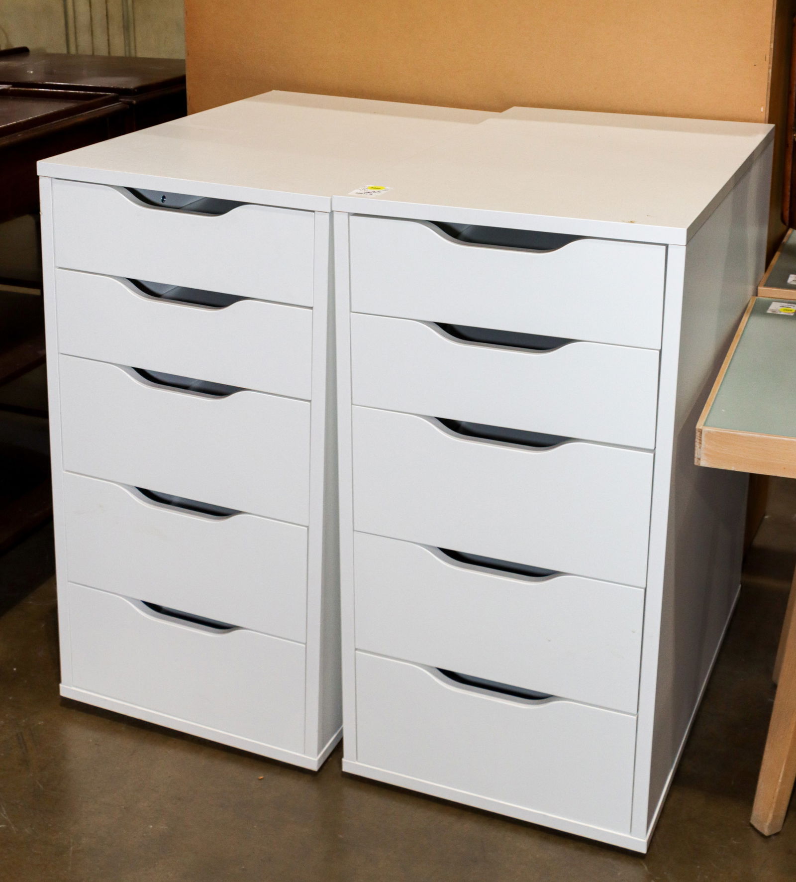 A pair of white bedside tables: A pair of white bedside tables, each with five drawers, 27.5"h 14"w x 23"d