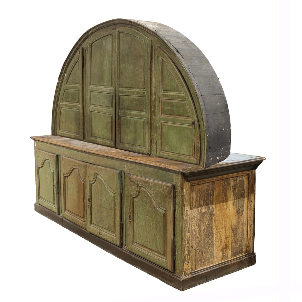 A monumental French Primitive paint decorated deux corps, circa 1780: A monumental French Primitive paint decorated deux corps, circa 1780, the top of dome form with four doors, opening to a robins egg blue interior, the lower case with panelled doors, and rising on a m