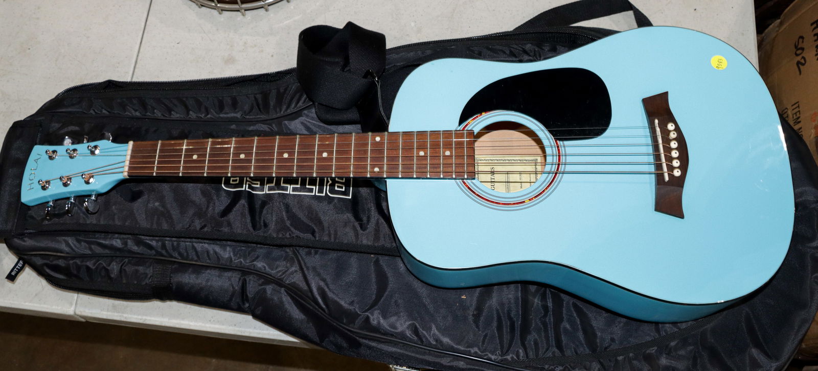 A Hola! Guitar light blue 3/4 scale acoustic guitar: A Hola! Guitar light blue 3/4 scale acoustic guitar, model HG-36LB, interior label, Ritter guitar soft case, 35.25"l (overall)