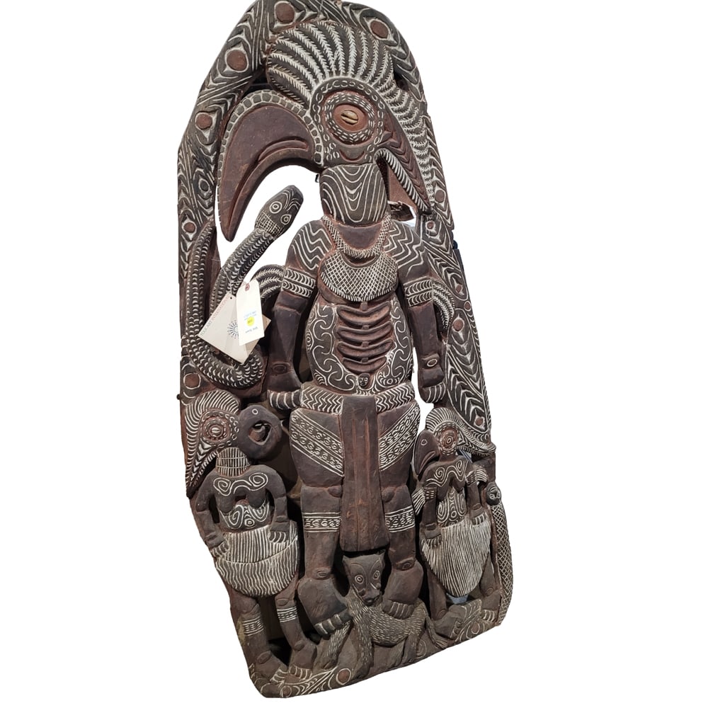 A large Oceanic polychrome carved storyboard panel: A large Oceanic polychrome carved storyboard panel, Papua New Guinea, incorporating animal headed figures, approx 56"h x 29"w
