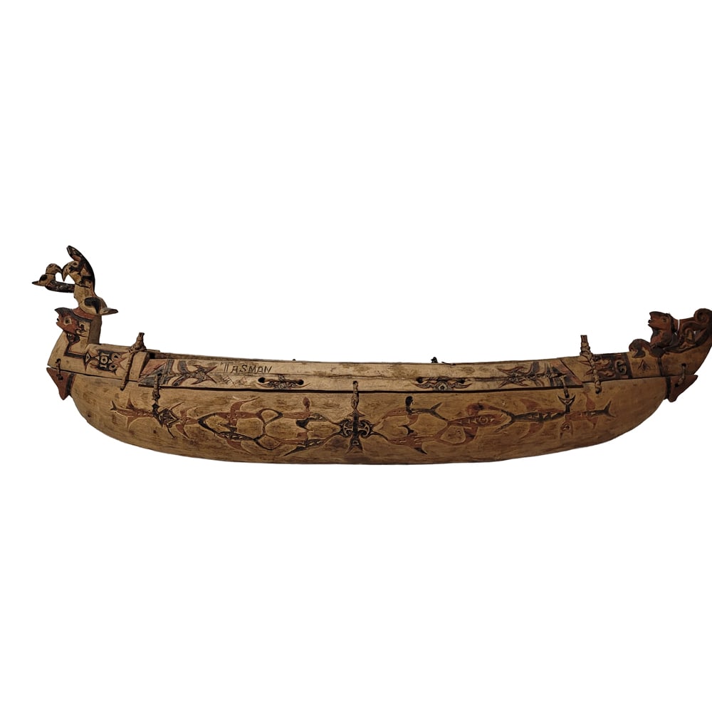 An Oceanic polychrome carved boat model: An Oceanic polychrome carved boat model, likely Maori, inscribed 'Tasman', approx 14"h x 3.5"w x 43.5"d