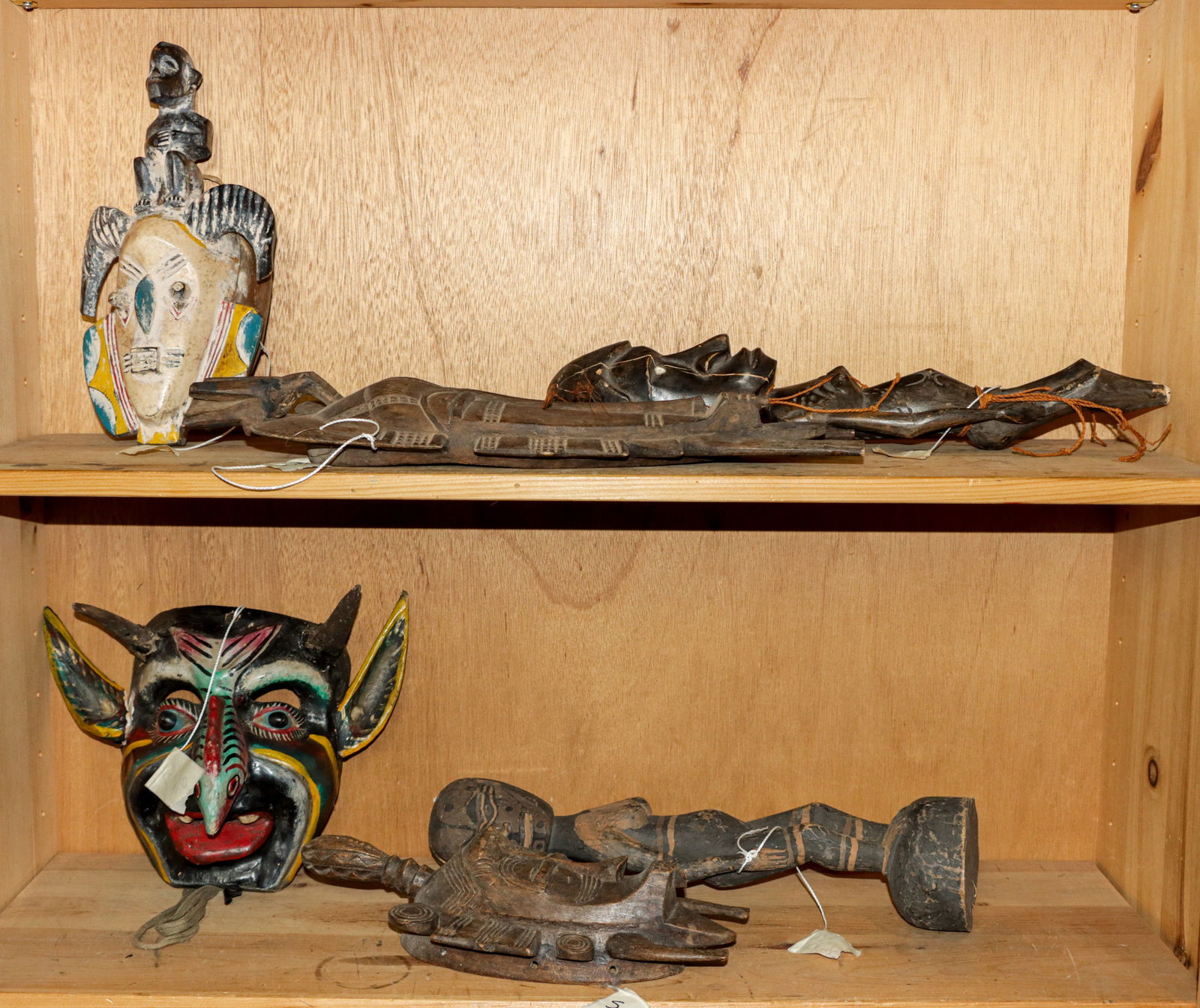 A group of six tribal style masks and figures: A group of six tribal style masks and figures, between 12.5"h and 18"h