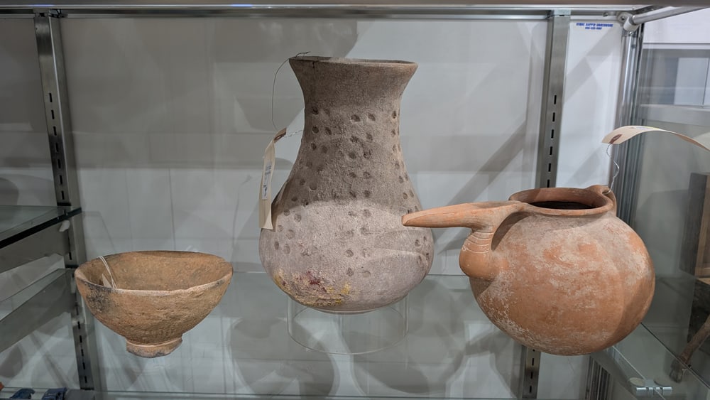 An assembled pottery group: An assembled pottery group, including Middle Eastern ewer with long spout, 7"h x 11"w; Mali d'jenne terra cotta bowl, 4"h x 6"dia, and pottery vessel, 10.5"h x 5.5