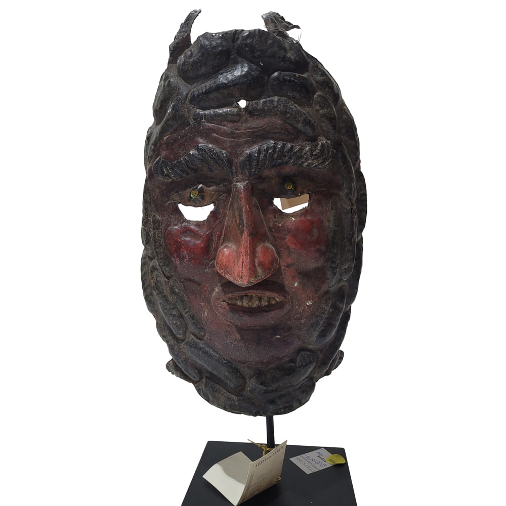 A Mexican painted metal turtle mask: A Mexican painted metal turtle mask, raised on stand, approx 18"h x 6"w x 6"d (overall)