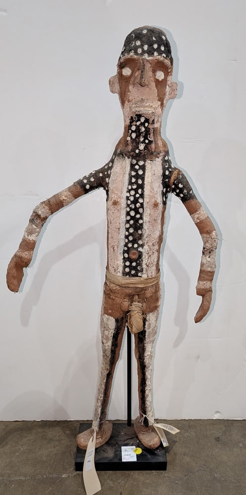 An Oceanic fiber painted figure of a man: An Oceanic fiber painted figure of a man, Papua New Guinea, raised on stand, approx 35.5"h x 15.5"w x 5"d (overall)