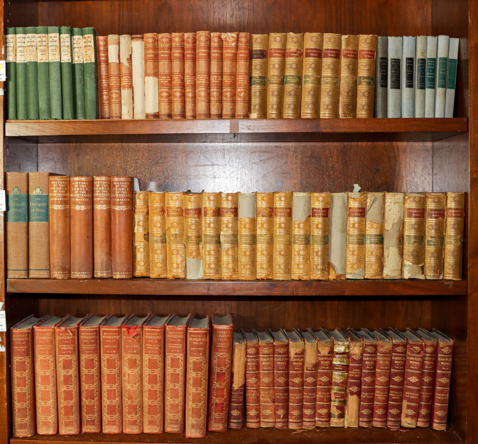 A collection of antique fiction and poetry books: A collection of antique fiction and poetry volumes, mainly leather bound books, including (12) volumes of Hawthornes Works; (7) volumes of Thackerays Works; (15) volumes of Dickens Works; (10) volumes