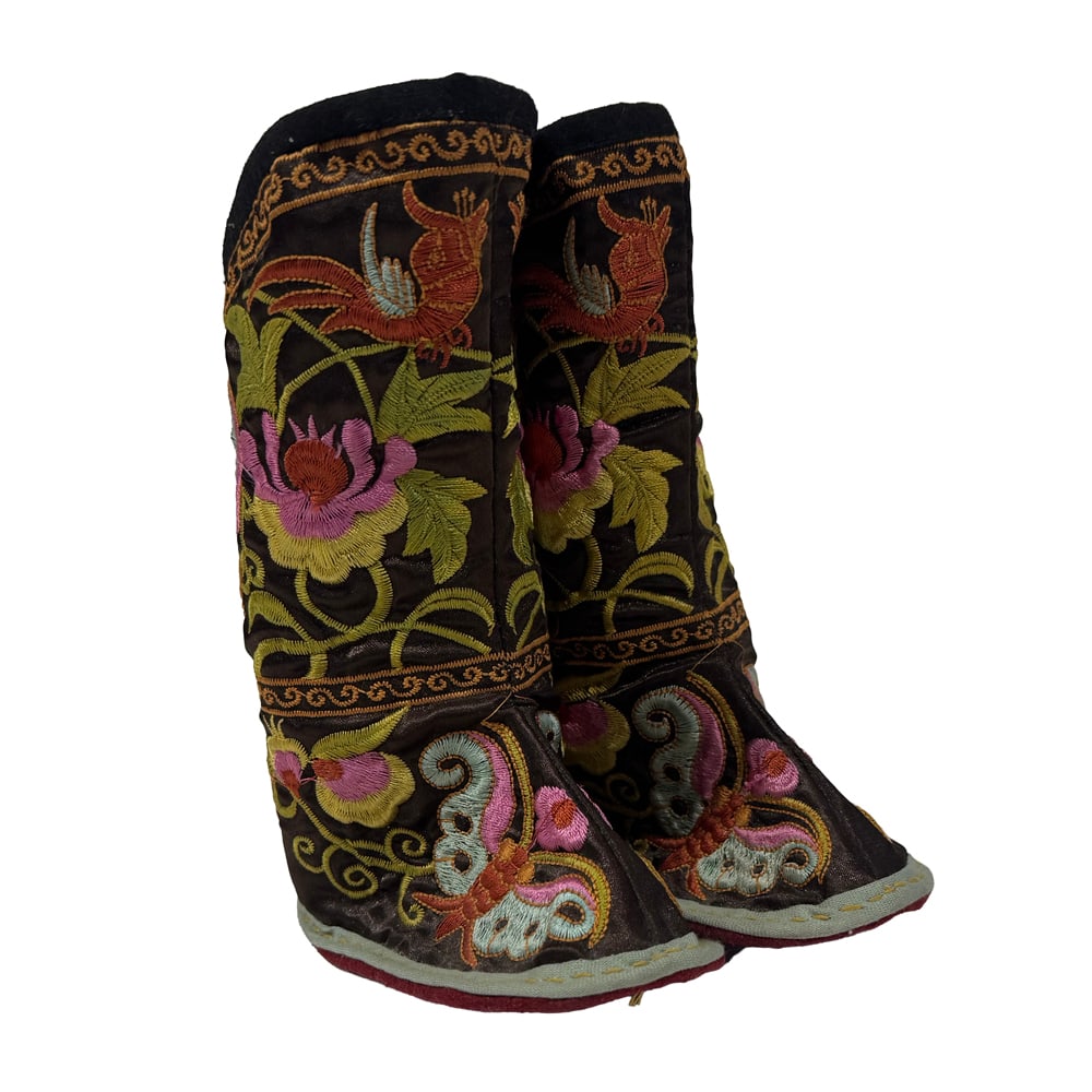 A pair of Chinese embroidered children's boots: A pair of Chinese embroidered children's boots. Featuring floral and butterfly design, 20th century, 6.75" high.