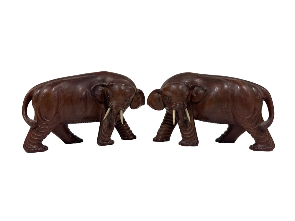 A pair of Southeast Asian carved hardwood elephants: A pair of Southeast Asian carved hardwood elephants. 5.75" high.