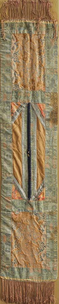 A Tibetan brocade woven shoulder scarf for a lama: A Tibetan brocade woven shoulder scarf for a lama. Circa 1920s, mounted as a wall panel, 12"h x 57"w.