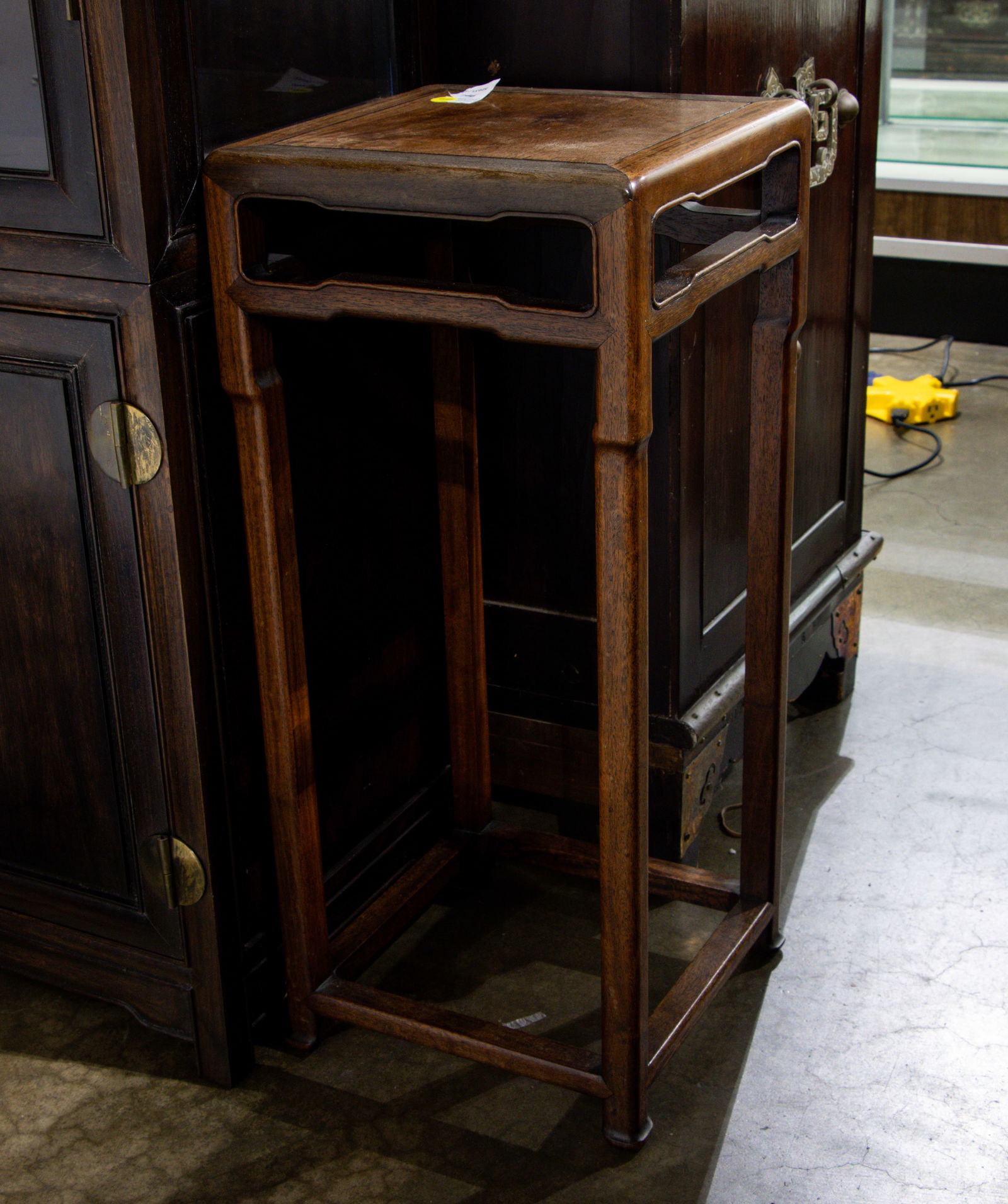 A Chinese hardwood square form side table: A Chinese hardwood square form side table. 20th century, 26.5"h x 11.5"w.