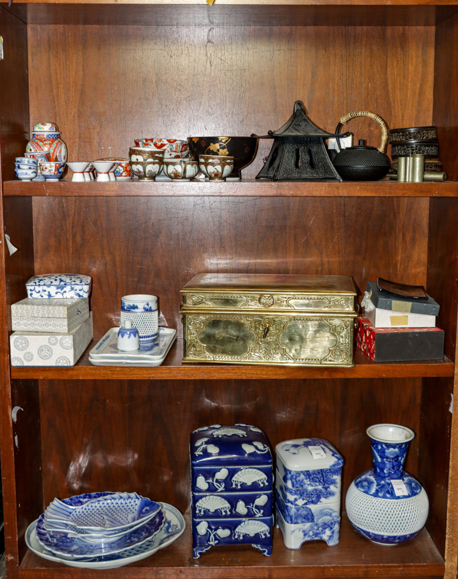 Three shelves of Asian decorative objects: Three shelves of Asian decorative objects. 20th century, 15.5" widest.