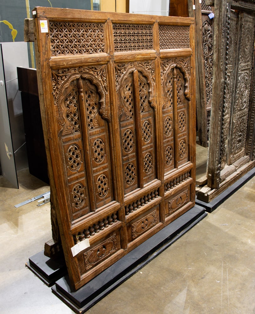 An Indian three-panel carved wood window panel: An Indian three-panel carved wood window panel. 18th century, modern metal stand, 51"h x 44"w excluding the stand.
