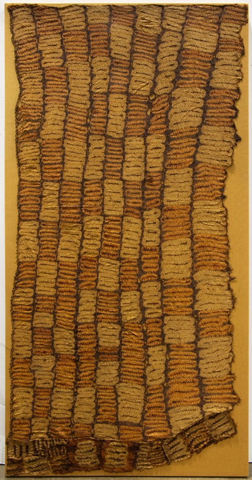 A Ceremonial plaited and tie dyed rafia skirt: A Ceremonial plaited and tie dyed raffia skirt, Dida people, Ivory Coast, mounted, 34"h X 69"w