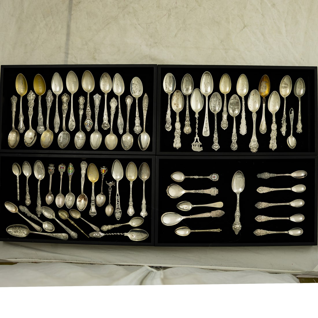 A collection of souvenier spoons in sterling and silverplate (1 of 2)