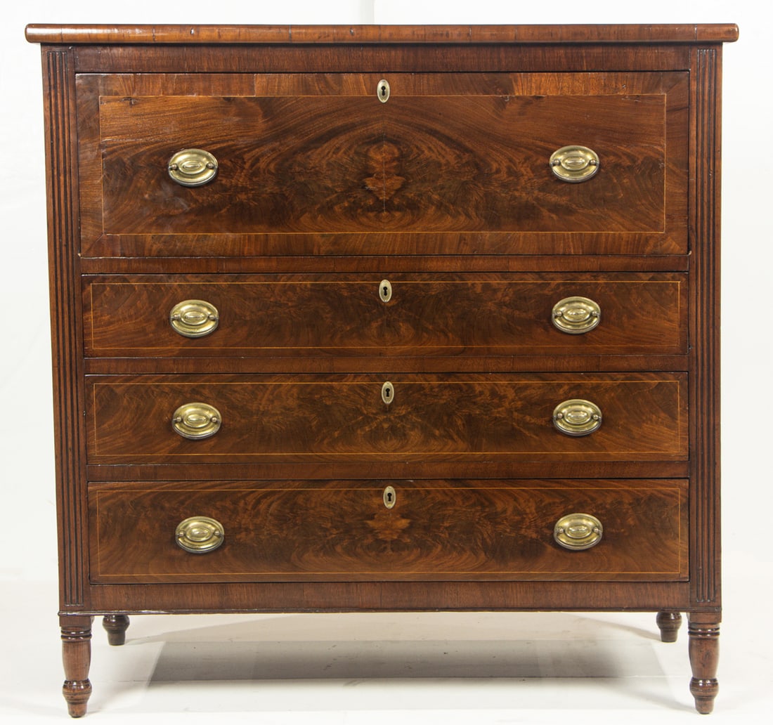 A Regency mahogany butler's chest: A Regency mahogany butler's chest, first half 19th century, the rectangular top over flame mahogany fall front opening to fitted interior with arrangement of drawers and cubby holes, all over three