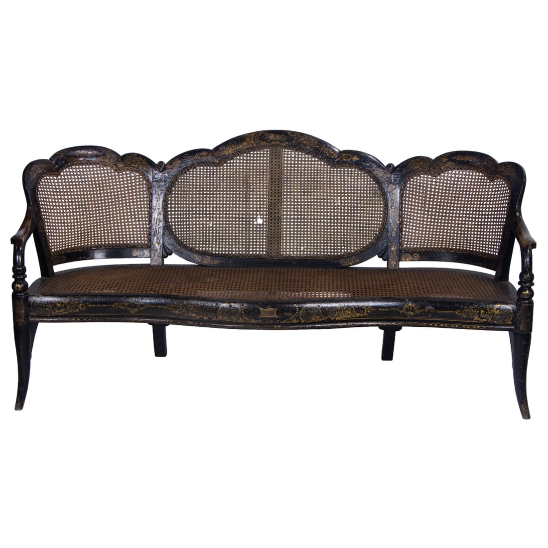 A Victorian gilt decorated ebonized and caned settee: A Victorian gilt decorated ebonized and caned settee, mid-19th century, the three-section curved back with scalloped crestrail issuing curved arms, over a shaped seat, ending on out swept legs, 36.5"h