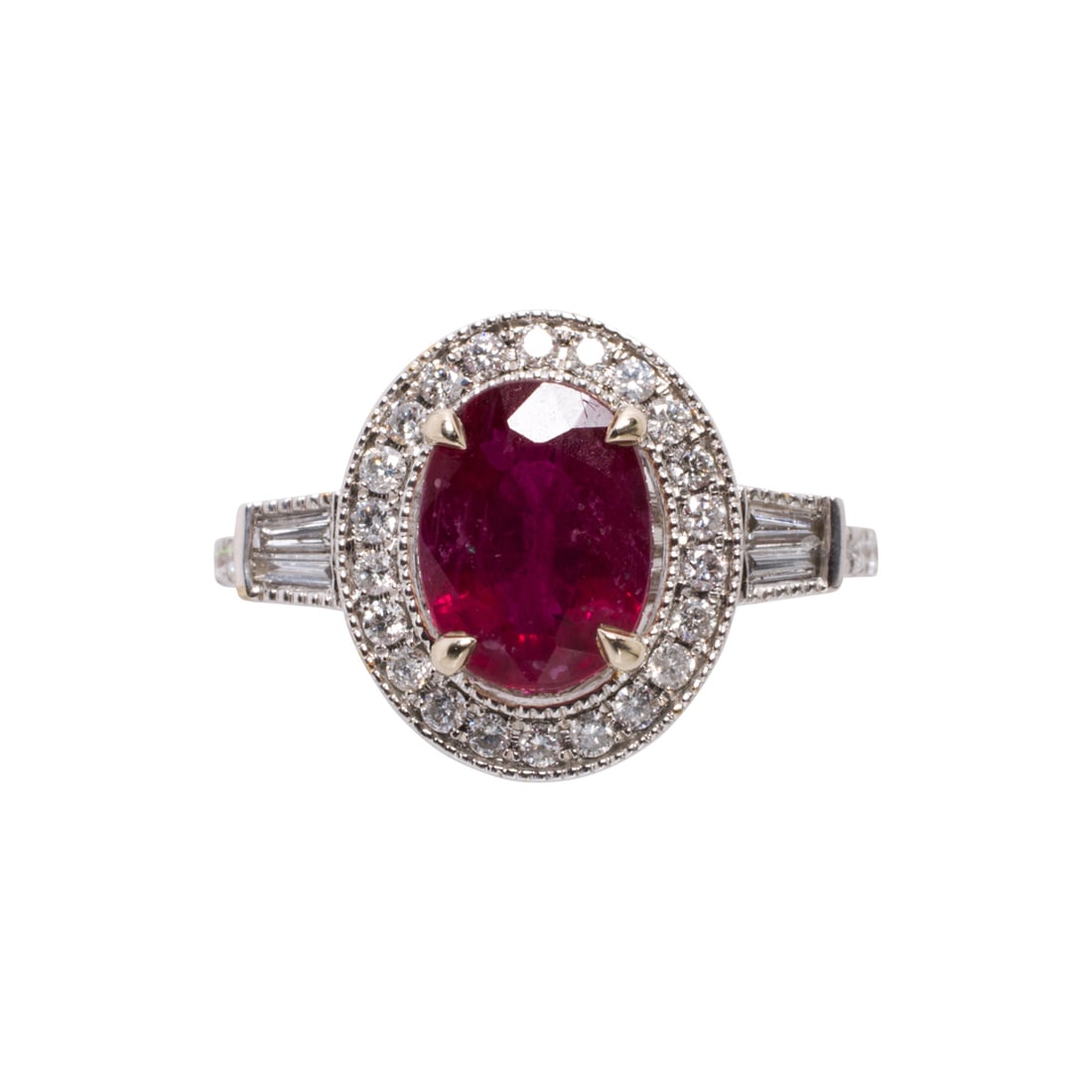 An Art-Deco style ruby, diamond, and 14k white gold ring: An Art-Deco style ruby, diamond, and 14k white gold ringFeaturing an oval-cut ruby weighing approximately 2.00 carats, framed by a halo of round brilliant-cut diamonds, with shoulders set with tapered