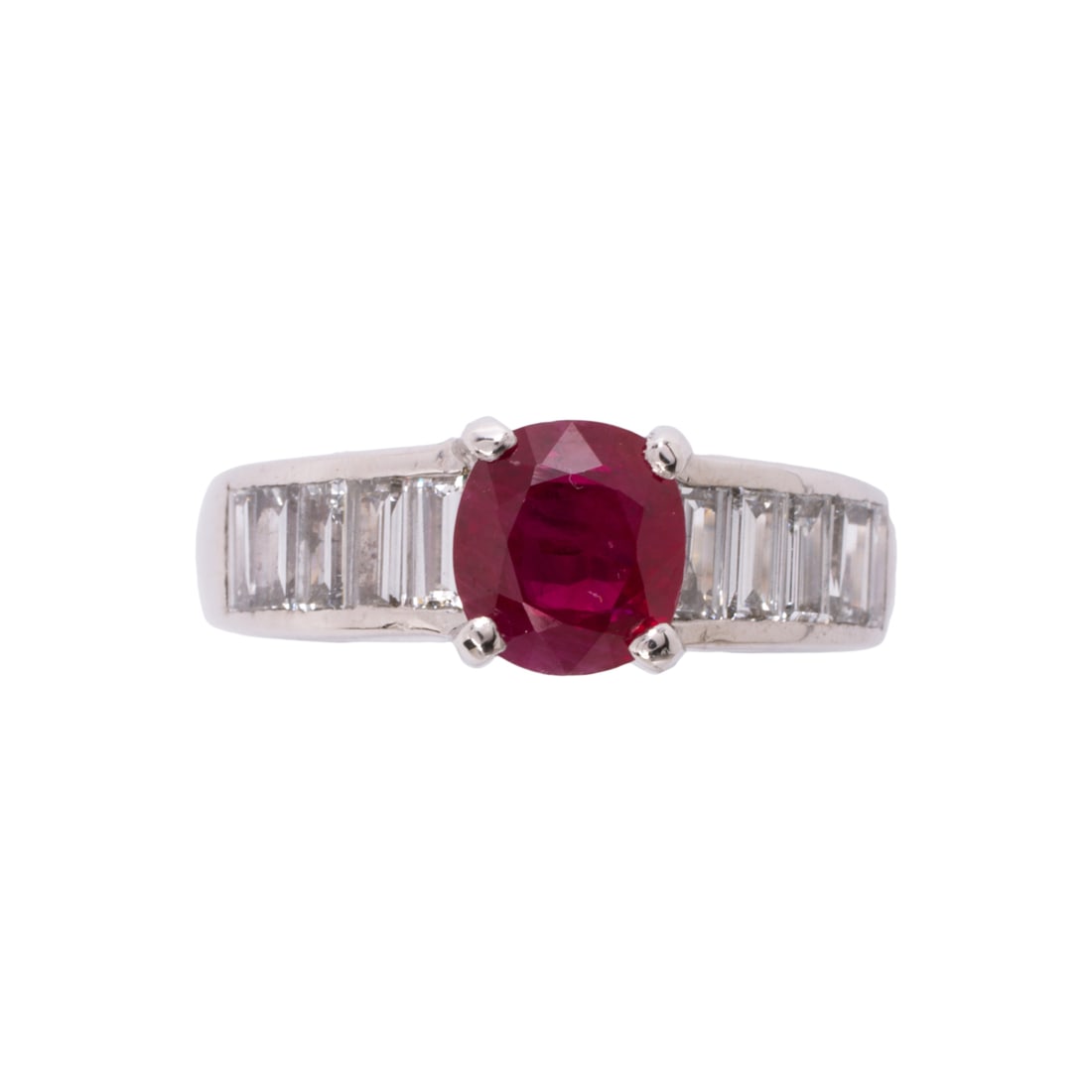A Burmese ruby, diamond, and 18k white gold ring: A Burmese ruby, diamond, and 18k white gold ringCentering a cushion-cut ruby weighing 2.01 carats, accented by baguette-cut diamond shoulders; estimated total diamond weight: 1.00 carat; 8.6 grams; si